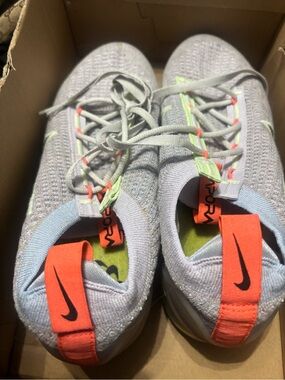 Nike women’s Light Gray Knit Sneakers with Coral Heel Tabs
